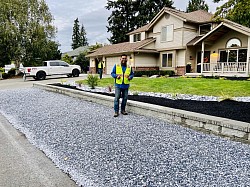 New gravel, retaining wall, beauty bark, plants, large rock